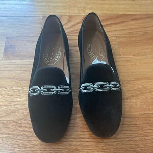 Black velvet loafers with silver stitch .